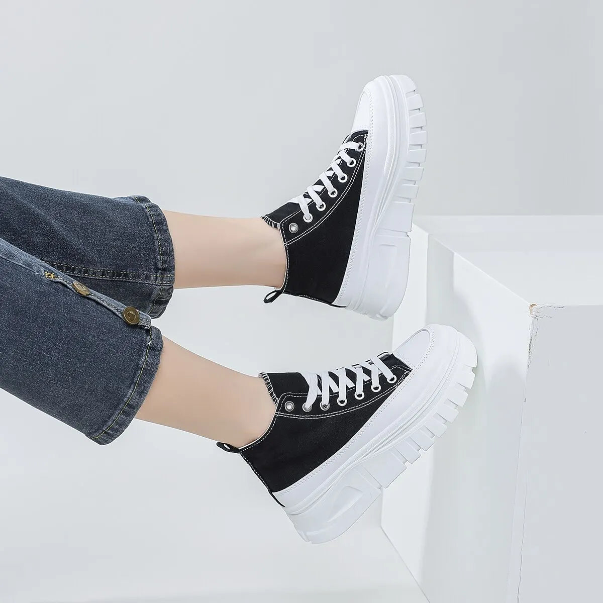 White canvas sneakers with thick sole